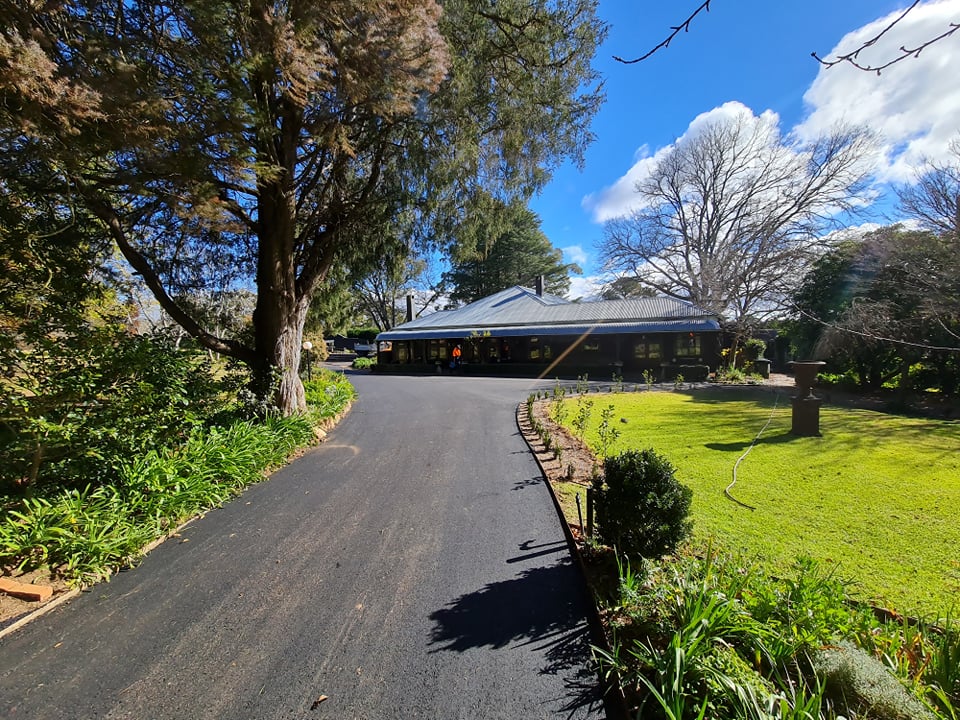 After — freshly laid asphalt driveway